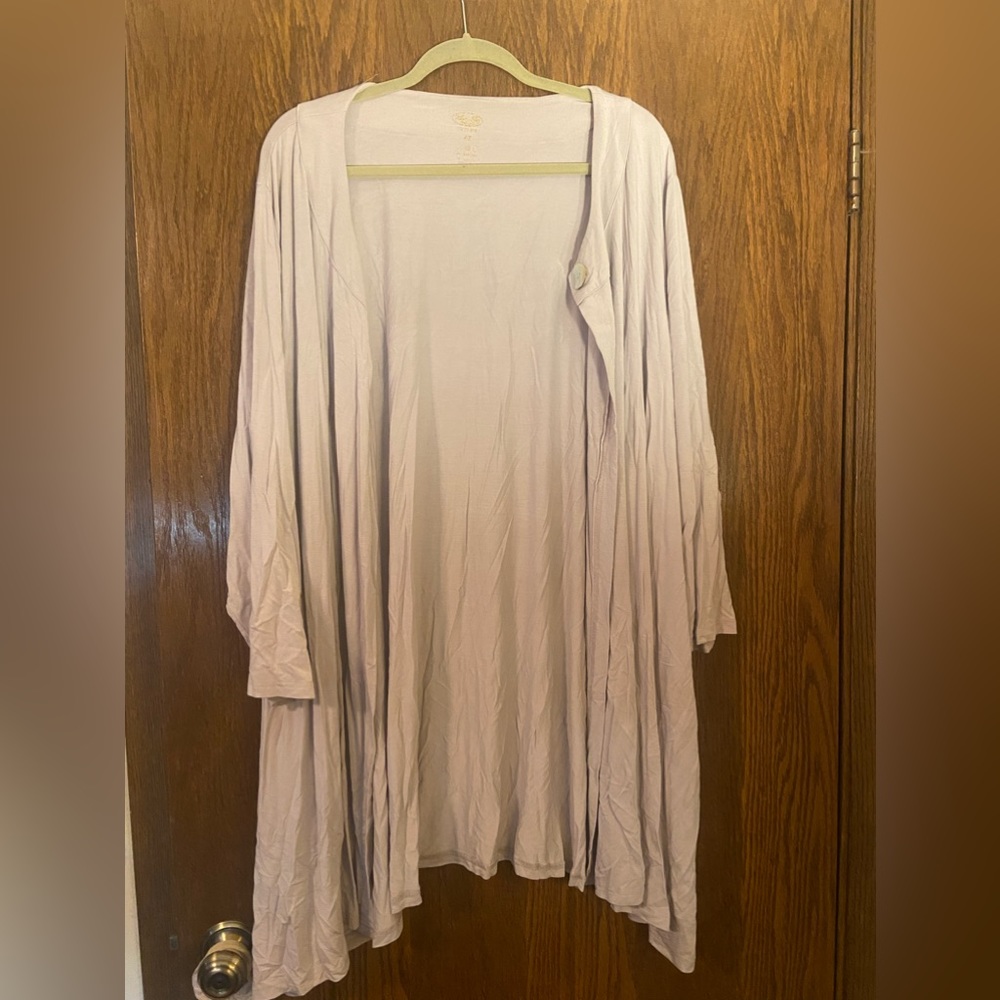 Cardigan with a single mother of pearl button at the top.